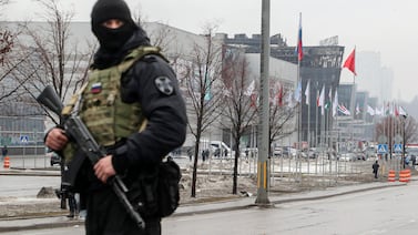 A Russian policeman guards near the Crocus City Hall. Intelligence analysts have told The National that ISIS will launch more attacks to raise its profile as well as cash and recruits. EPA