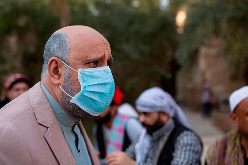 Iraqi actor Mohammad Qassem, the main character of a parody sketch video of Bab al-Hara, an adaptation of an iconic long-running Syrian television drama, wears a face mask while acting on set in Iraq's southern port city of Basra on April 22, 2020. AFP / Hussein Faleh
