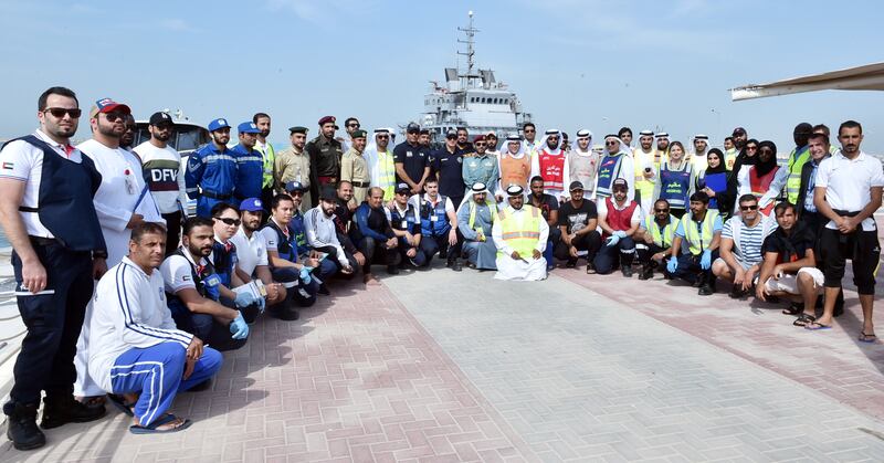 Dubai Police marine personnel and staff from the RTA authority pose for a photo after a drill that saw them respond to a ferry that caught on fire