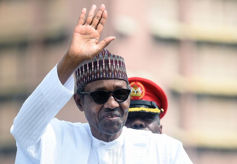 (FILES) In this file photo taken on June 12, 2019 Nigerian President Muhammadu Buhari salutes during an inspection of guards on parade to mark Democracy Day in Abuja, on June 12, 2019. A Nigerian court on September 11, 2019 upheld President Muhammadu Buhari's election victory earlier this year, dismissing a request by opposition parties to overturn the result over claims of voting irregularities. Buhari, 76, won a second term with 56 percent of the February poll, which was long delayed and marred by violence.

 / AFP / PIUS UTOMI EKPEI
