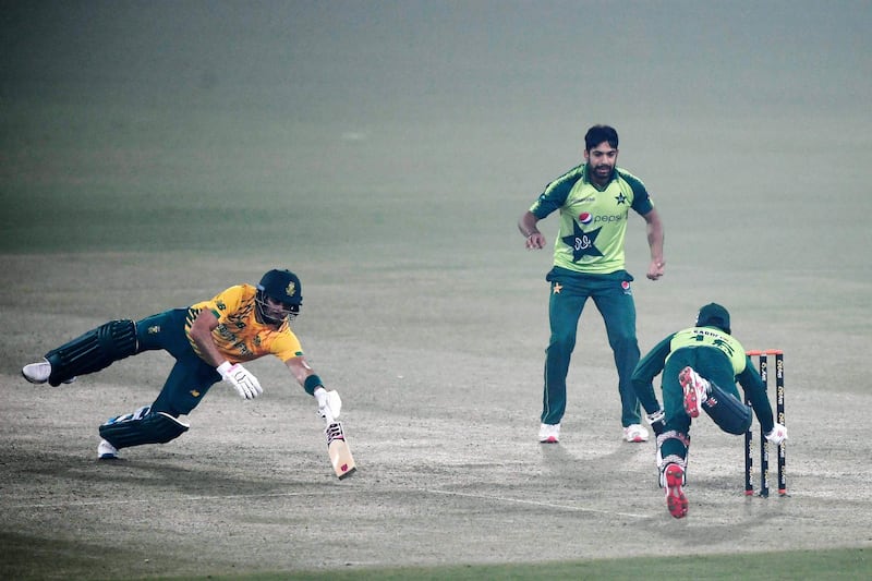 Pakistan's wicketkeeper Mohammad Rizwan runs of South Africa's Reeza Hendricks out as teammate Haris Rauf watches during the first T20 in Lahore. AFP