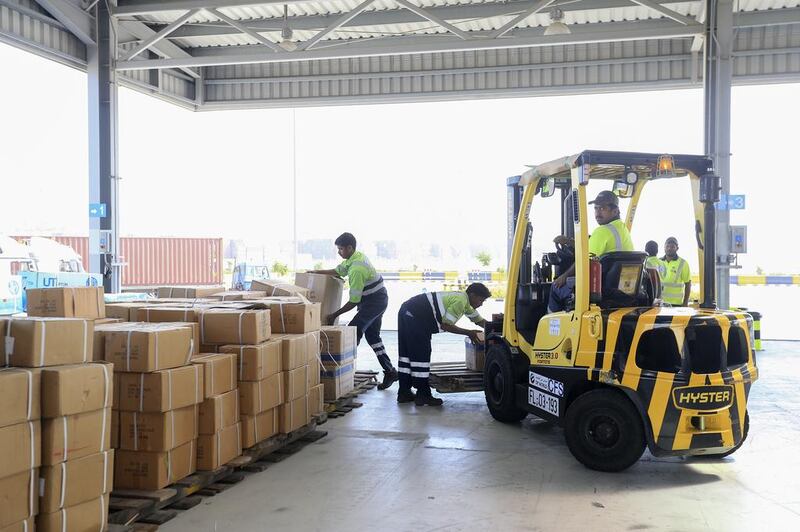 Workers unload shipments for inspection at Dubai Customs in Jebel Ali Port. Sarah Dea / The National