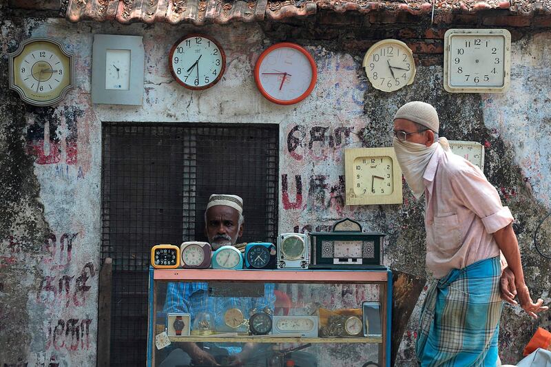 A watchmaker waits for customers  in Chennai.   AFP