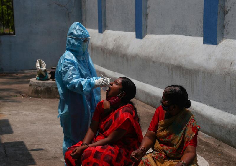 A health worker takes a mouth swab sample at a hospital in Hyderabad. AP Photo