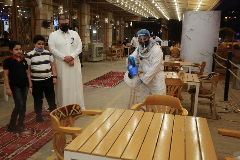 A worker sterilises tables at a restaurant in Riyadh, Saudi Arabia. Reuters