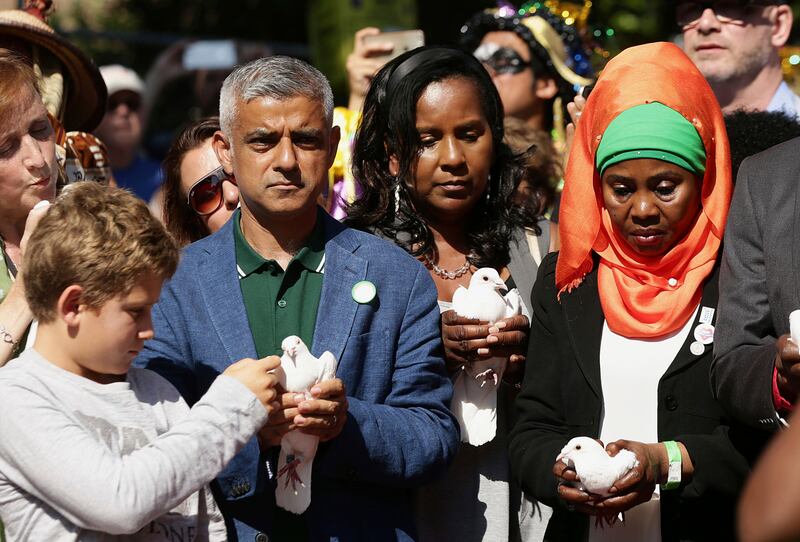 Mayor of London, Sadiq Khan, 2nd left, takes part with others in a release of doves as a show of respect for those who died in the Grenfell Tower fire, during the Notting Hill Carnival Family Day in west London, Sunday Aug. 27, 2017. (Yui Mok/PA via AP)