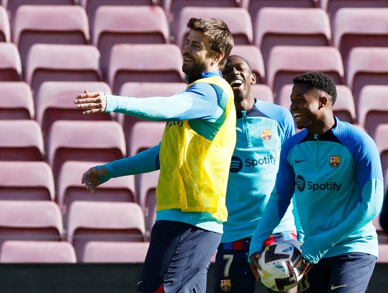 Barcelona's Gerard Pique with Ansu Fati and teammates during training. Reuters