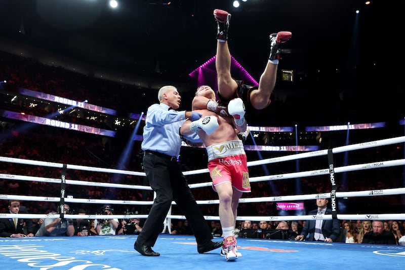 Canelo Alvarez picks up Dmitry Bivol during their WBA light heavyweight title fight at T-Mobile Arena.