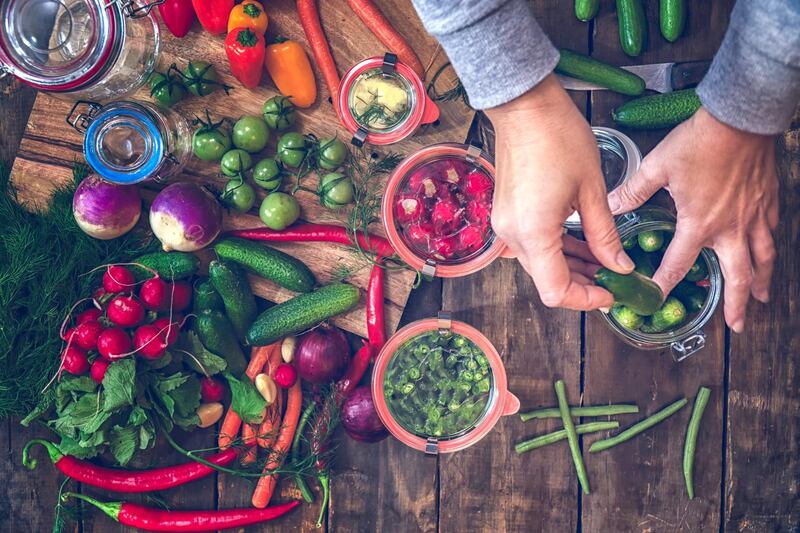 Preserving organic vegetables in jars like carrots, cucumbers, tomatoes, chilis, paprika and radishes. Getty Images