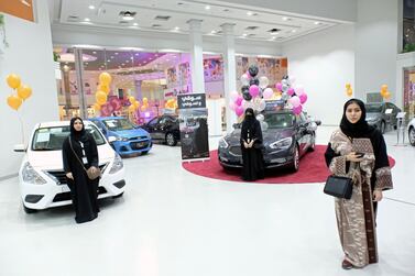 Saudi women are seen at the first automotive showroom solely dedicated for women in Jeddah. Lifting a ban on female drivers is among reasons the kingdom's economy is likely to benefit from increased female economic participation. Reem Baeshen/Reuters