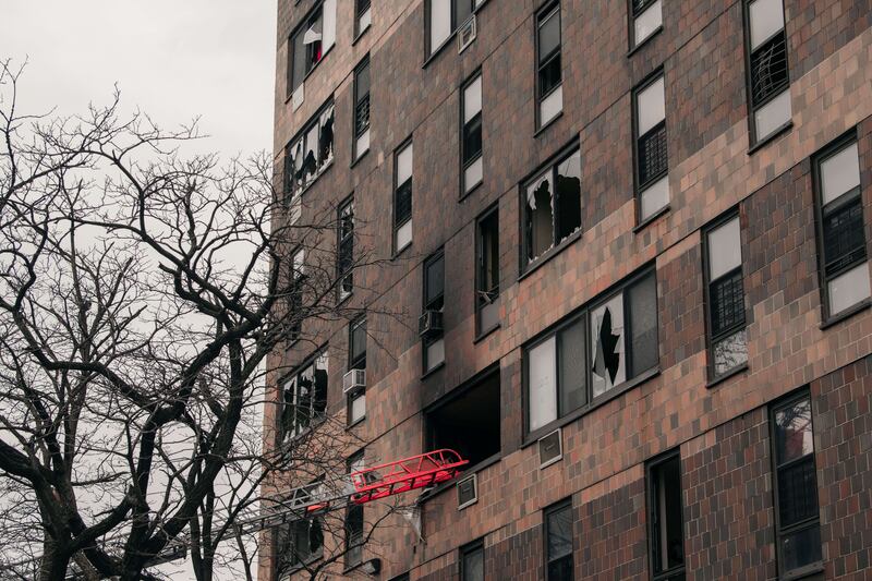 Broken windows and charred bricks scar the exterior of the 19-storey residential building. AFP