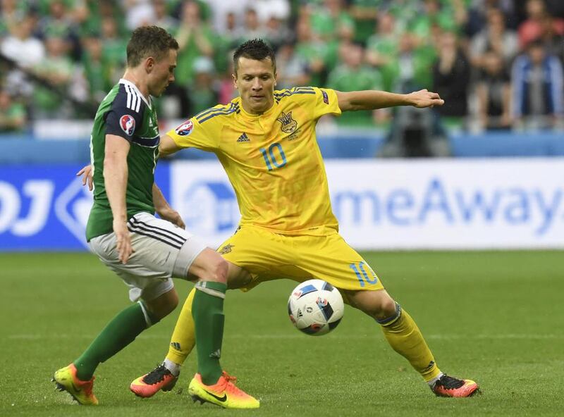 Northern Ireland defender Craig Cathcart, LEFT, vies with Ukraine midfielder Yevhen Konoplyanka. Philippe Desmazes / AFP