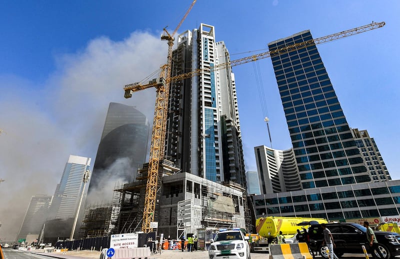 Smoke rises from a fire in a tower in the Business Bay area of Dubai. Karim Sahib / AFP