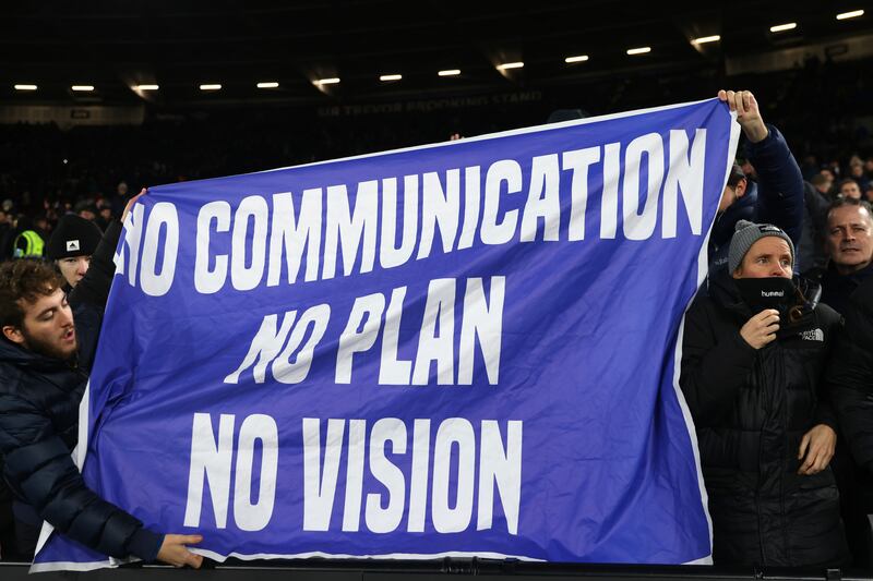 Everton fans hold banners aimed at the club's owners. Getty