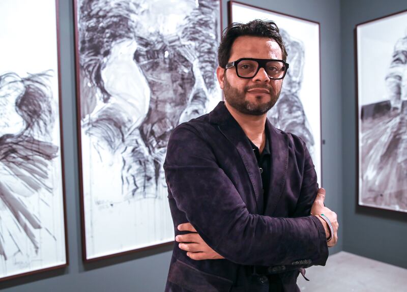 Harb at the opening of his exhibition. Victor Besa / The National