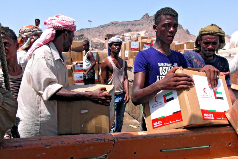 Yemenis unload an aid shipment provided by the Emirates Red Crescent at the port city of Aden. The charity group sent more than 830 tonnes of aid. A number of flights to the country containing medical and food aid were also organised by the Khalifa Foundation. EPA