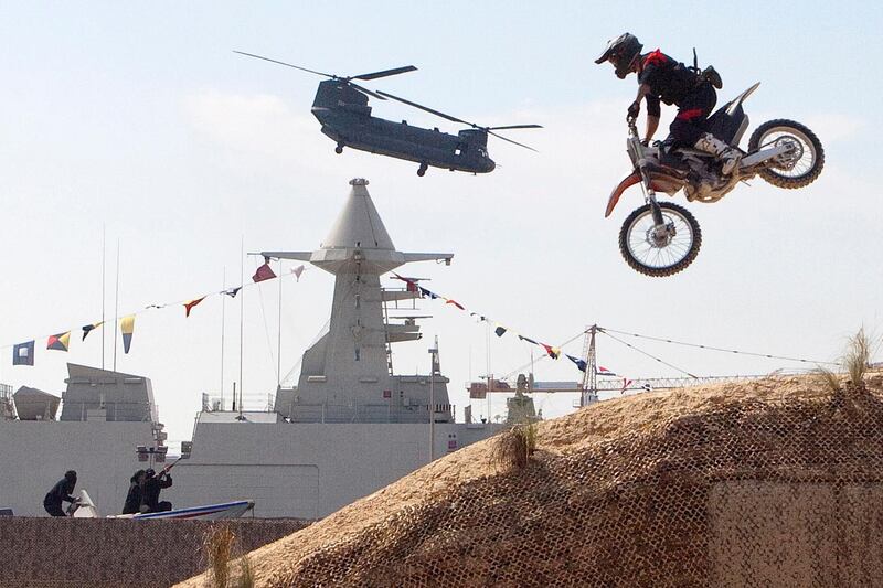 Dubai, United Arab Emirates, Feb 17, 2013 - Flying helicopters and motorcycles jumps during the inaguration ceremony of  IDEX, International Defense Exhibition Conference at Abu Dhabi Exhibition Centre, ADNEC.   ( Jaime Puebla / The National Newspaper ) 