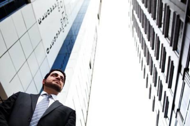 ABU DHABI, UAE - July 5, 2011-  Munther Al Bakri, director of Gavity Real Estate, stands in front of residential buildings in Abu Dhabi.  Freelance real estate agents have been levying outrageous charges on residents and the municipality is cracking down on the practice.   (Andrew Henderson / The National)