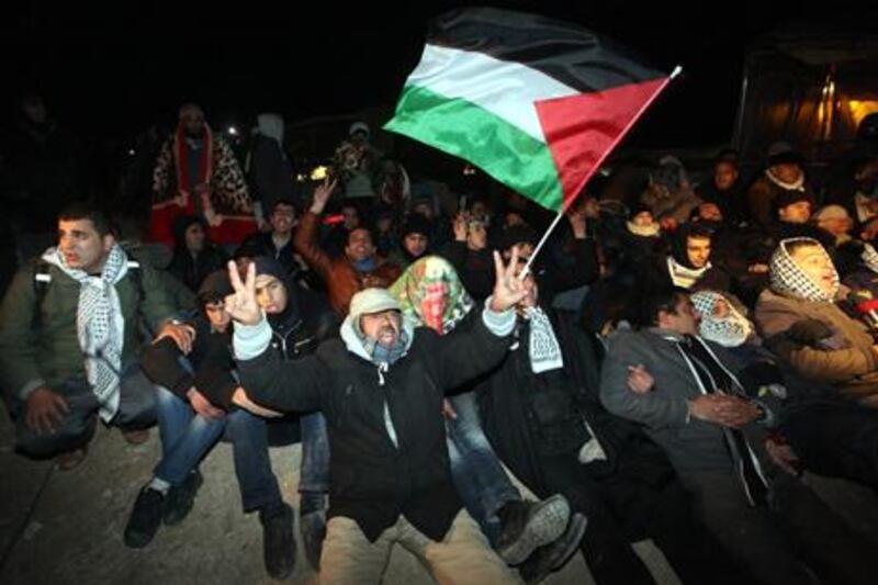 Palestinian protesters hold hands and rest on the ground before the Israeli border police start with their evacuation operations from a ' tent city outpost' called Bab al-Shams (Gate of the Sun).  EPA/ Abir Sultan