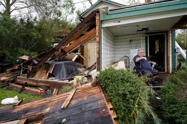 Chris Johnson views destruction at his home in Lake Charles, Louisiana after Hurricane Laura moved through the state.  Oil and gas exports from the US were severely disrupted due to the hurricane. (AP Photo/Gerald Herbert)