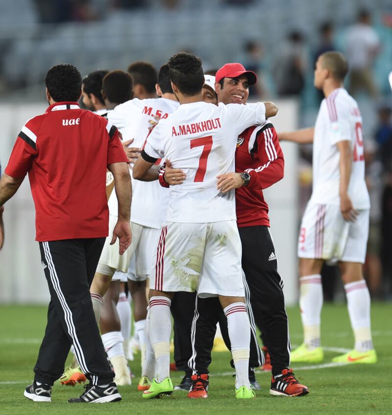 UAE coach Mahdi Ali, second right, congratualtes Ali Mabkhout after their victory over Japan at the Asian Cup in Melbourne, Australia, on Januaury 23, 2015. Courtesy UAE FA