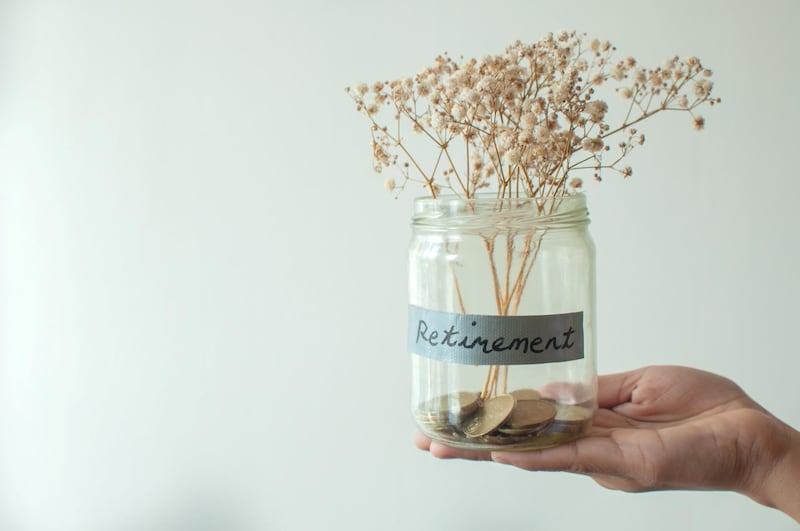 A hopeless retirement concept jar with coins and dried plant