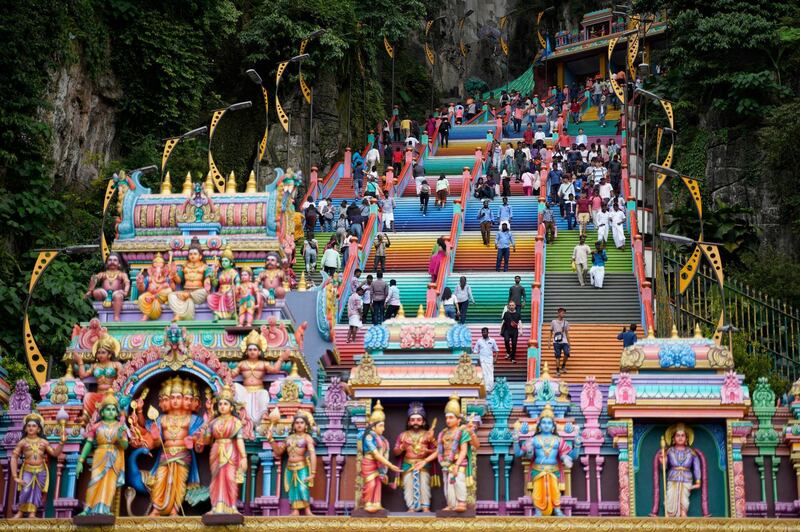 Hindu devotees climb the colored stairs to pray at the Batu Caves Temple during the Deepavali celebration in Selangor, Malaysia. AP