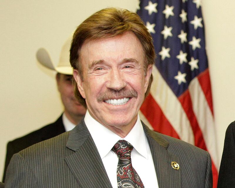 FILE - In this Dec. 2, 2010, file photo, actor Chuck Norris stands following a ceremony in Garland, Texas. Norris' manager says the â€œWalker, Texas Rangerâ€ star was not present at last weekâ€™s deadly riot at the U.S. Capitol. A photo of a man resembling Norris apparently with a member of the mob began trending online.  (AP Photo/Tony Gutierrez, File)