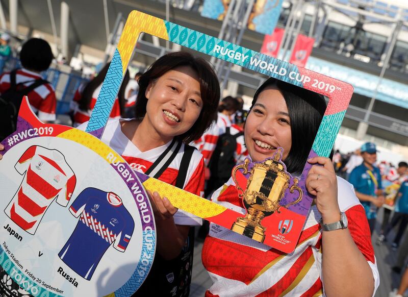 Japanese fans pose for a photo as they arrive at Tokyo Stadium. AP Photo