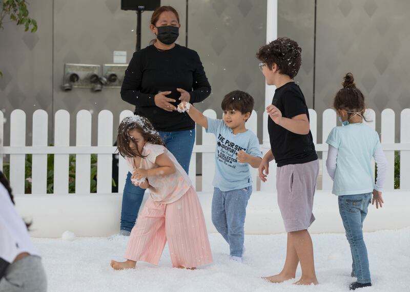 Children playing in faux snow.