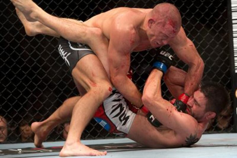 UFC welterweight champion Georges St. Pierre lands a blow to interim champion Carlos Condit in their unification bout.