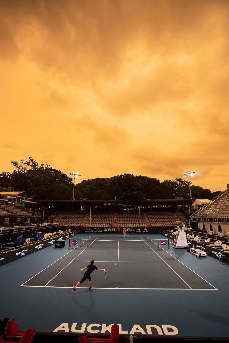 Players practice ahead of the ASB Tennis Classic as the sky in Auckland turns orange as smoke from the Australia bushfires arrive in New Zealand, on Sunday, January 5,. AP
