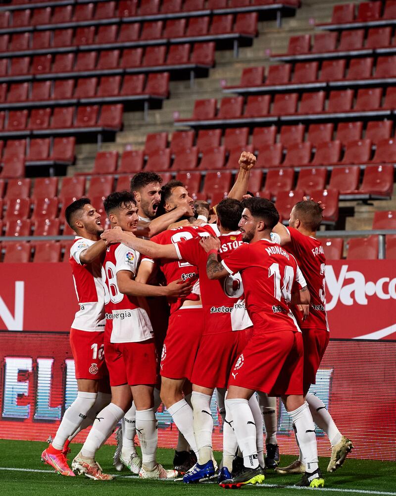GIRONA, SPAIN - MAY 17: Girona FC players celebrate their team's first goal scored by Juan Pedro 'Juanpe' Ramirez during the Liga Smartbank match betwen Girona FC and Real Sporting at Montilivi Stadium on May 17, 2021 in Girona, Spain. Sporting stadiums around Spain remain under strict restrictions due to the Coronavirus Pandemic as Government social distancing laws prohibit fans inside venues resulting in games being played behind closed doors. (Photo by Alex Caparros/Getty Images)