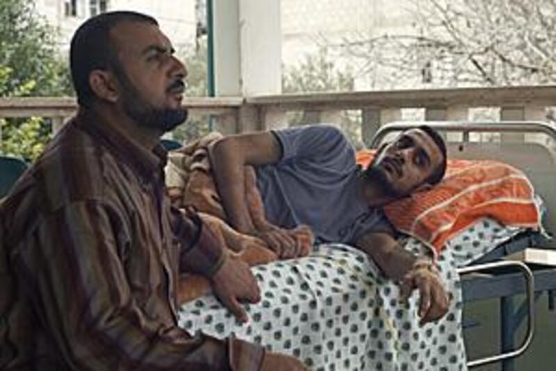 Maher Habashi, 24, lost a leg in the recent Israeli attacks and is starting a rehabilitation programme at Al Wafa Hospital, below, which was severely damaged in the bombardment. Maher's brother Mahmoud, 33, above left, also attends the programme to learn how to care for his brother.