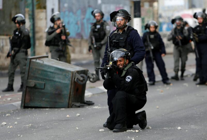 An Israeli policeman aims his weapon during clashes with Palestinians at a protest in Bethlehem on December 7, 2017. Mussa Qawasma / Reuters