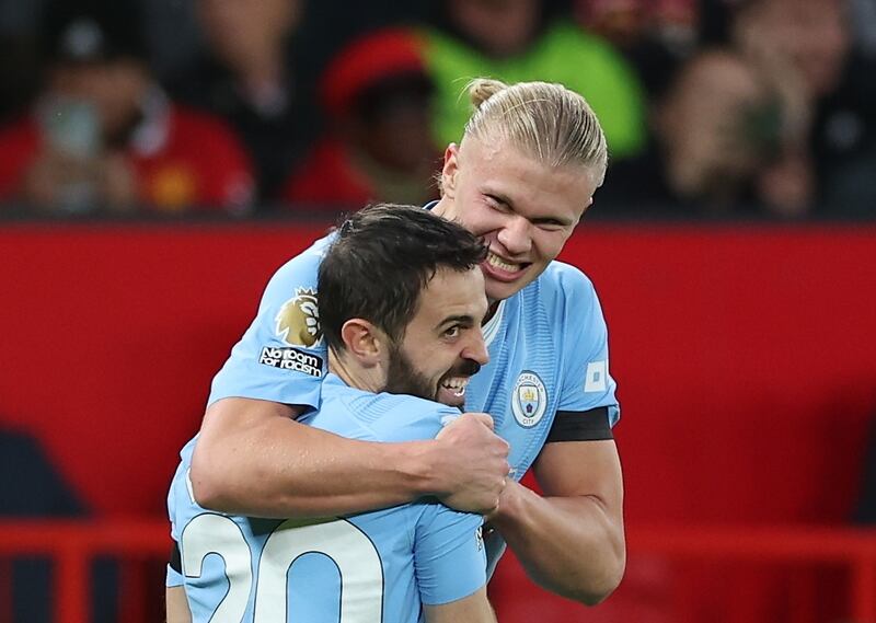 Erling Haaland of Manchester City celebrates with teammate Bernardo Silva. EPA