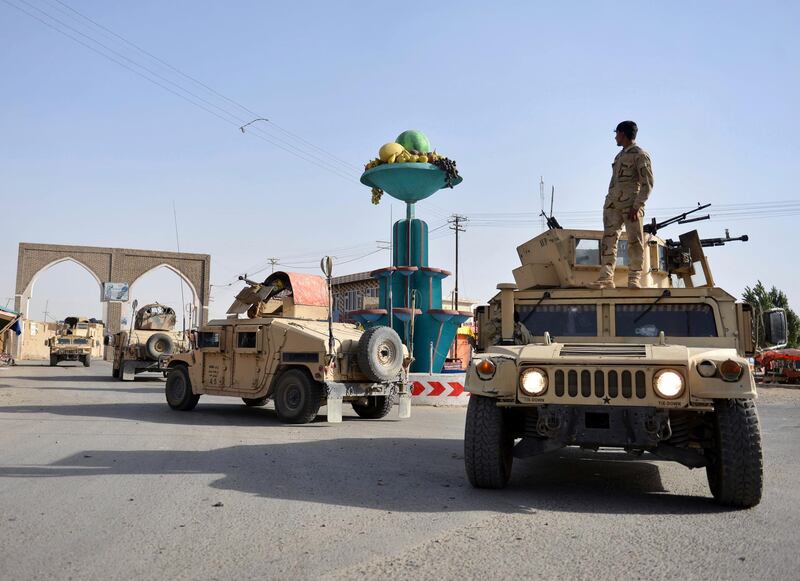 FILE - In this Sunday, Aug. 12, 2018 file photo, Afghan Security personnel petrol in the city of Ghazni province west of Kabul, Afghanistan. Talks next month in Moscow to discuss a peaceful end to 17-years of war in Afghanistan that includes a place at the table for the Taliban has ruffled feathers in Washington and Kabul, who are refusing to attend, and resurrected Cold War memories. (AP Photo/Mohammad Anwar Danishyar)