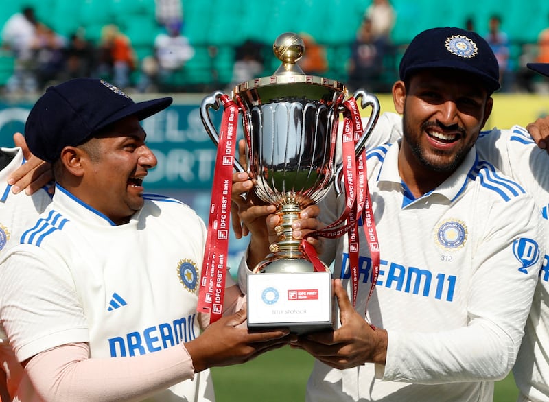 Sarfaraz Khan, left, and Dhruv Jurel lift the Test series trophy after India defeated England 4-1 in Dharamsala. Reuters