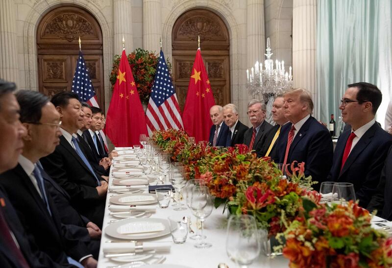 US President Donald Trump (2-R) US Secretary of the Treasury Steven Mnuchin (R) and members of their delegation have dinner with China's President Xi Jinping (3-L) and Chinese government representatives, at the end of the G20 Leaders' Summit in Buenos Aires, on December 01, 2018. US President Donald Trump and his Chinese counterpart Xi Jinping had the future of their trade dispute -- and broader rivalry between the world's two top economies -- on the menu at a high-stakes dinner Saturday. / AFP / SAUL LOEB
