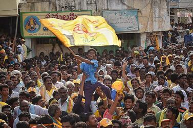 A young supporter of Telugu Desam Party waves a flag at a rally in Krishna district of the Indian state of Andhra Pradesh. AFP
