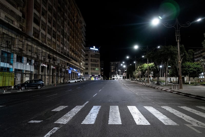 In this Tuesday March 24, 2020, photo, a street is empty in Dakar, Senegal as an 8pm to 6am curfew is enforced in an effort to fight the coronavirus outbreak. The new coronavirus causes mild or moderate symptoms for most people, but for some, especially older adults and people with existing health problems, it can cause more severe illness or death. (AP Photo/Sylvain Cherkaoui)