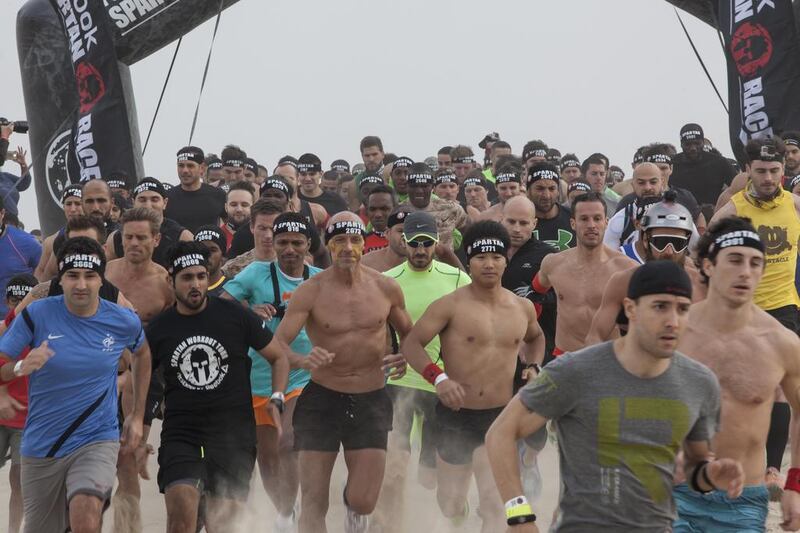 About 5,000 people trudged through mud, sand and various obstacles in the UAE's first Spartan Race. Antonie Robertson / The National