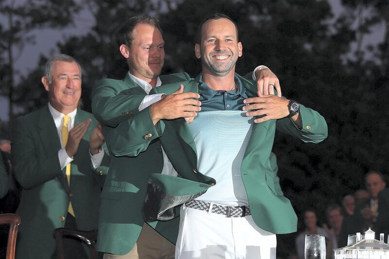 AUGUSTA, GA - APRIL 09: Danny Willett of England presents Sergio Garcia of Spain with the green jacket after Garcia won in a playoff during the final round of the 2017 Masters Tournament at Augusta National Golf Club on April 9, 2017 in Augusta, Georgia.   David Cannon/Getty Images/AFP