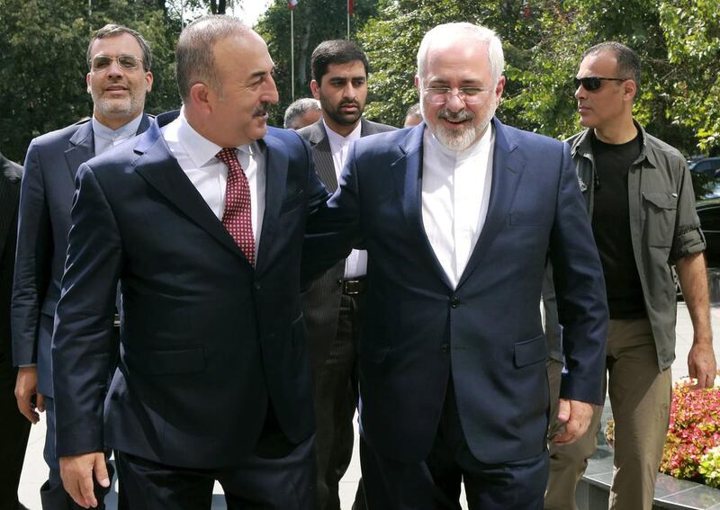Turkish foreign minister Mevlut Cavusoglu welcomes his Iranian counterpart Mohammad Javad Zarif for a meeting at the Foreign Ministry in Ankara on August 12, 2016. Adem Altan / AFP Photo