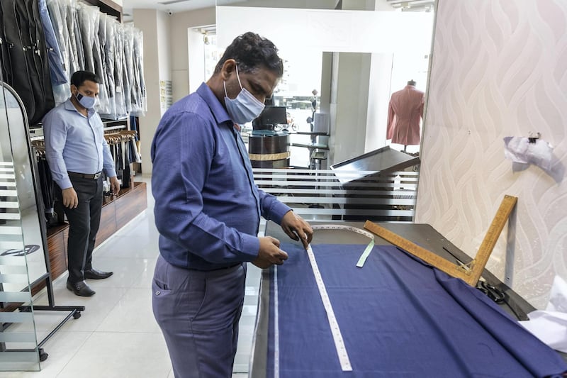 Eid Tailors. Tailors in Dubai are on the road to recovery as Eid outfit orders pick up this year compared to last year. Staff at Kachins in Bur Dubai do last minute work to get this years Eid outfit orders ready before the end of Ramadan tonight on May 10th, 2021. 
Antonie Robertson / The National.
Reporter: Kelly Clarke for National.