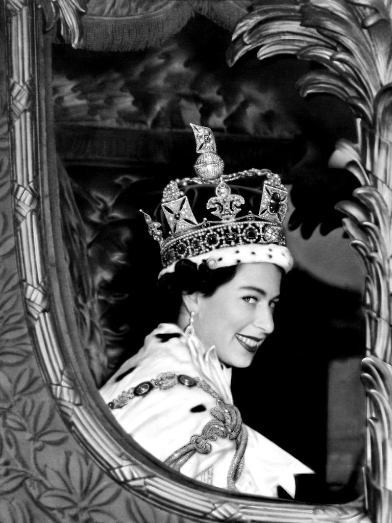 Queen Elizabeth II smiles to the crowd after her coronation in June 1953.