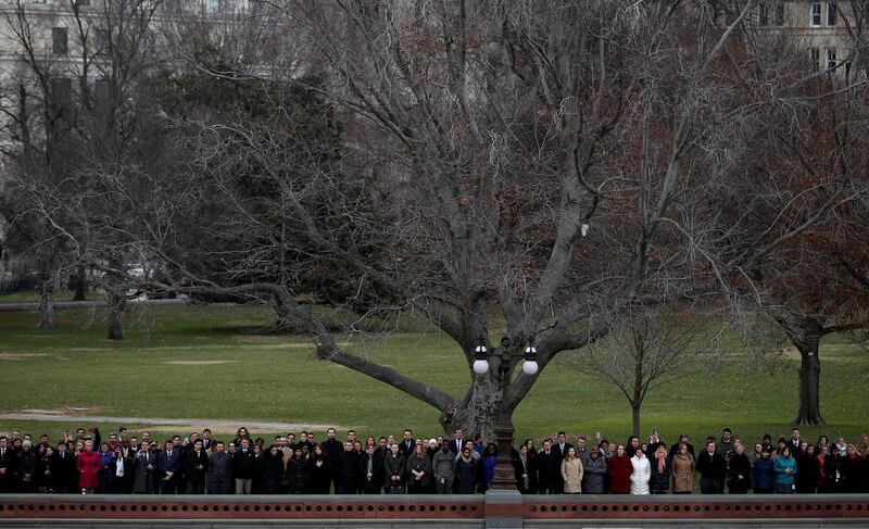 Spectators watch as a US military honor guard team carries the casket. Reuters