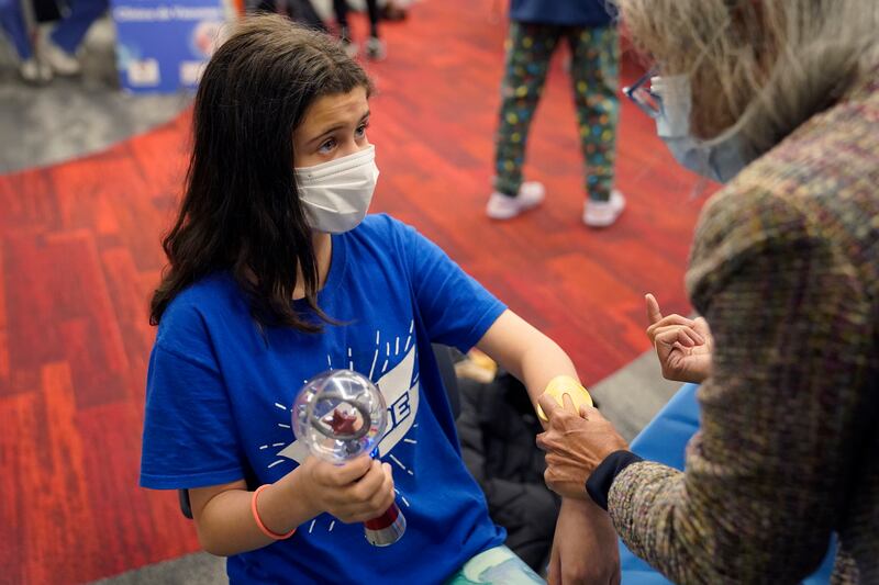 Jehna Kottori, 10, of Worcester, Massachusetts, prepares to receive a shot of the Covid-19 vaccine. AP