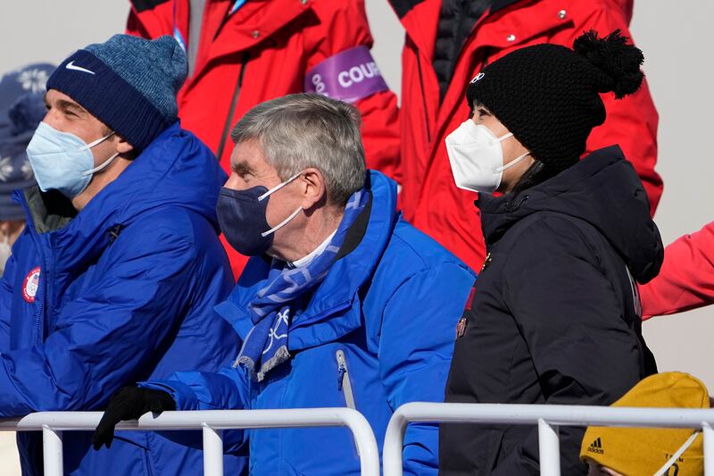 China's Peng Shuai, right, watches the women's freestyle skiing big air finals with Thomas Bach, center, president of the International Olympic Committee. AP