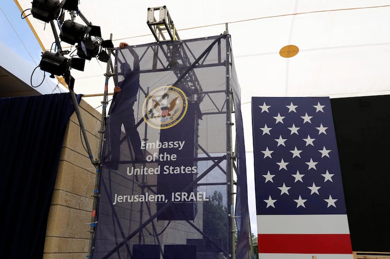 A worker prepares the ceremony stage inside the US consulate that will act as the new US embassy in the Jewish neighborhood of Arnona, on the East-West Jerusalem line in Jerusalem, on May 13, 2018. Abir Sultan / EPA